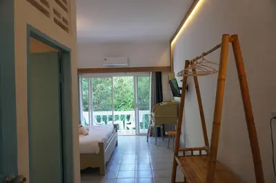 a room with a bed and a room with a ladder at Residy Retreat x Baan Suan Villa in Patong Beach