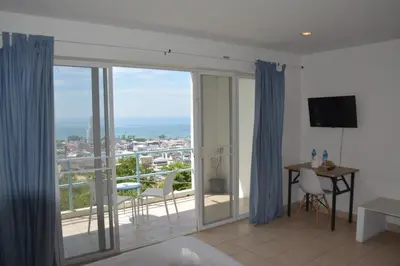 a living room with a view of the ocean at Residy Retreat x Baan Suan Villa in Patong Beach