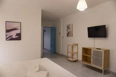 a living room with a bed and a tv at Residy Retreat x Baan Suan Villa in Patong Beach