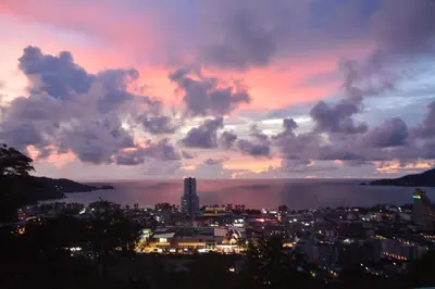 a view of a city with a sunset at Residy Retreat x Baan Suan Villa in Patong Beach