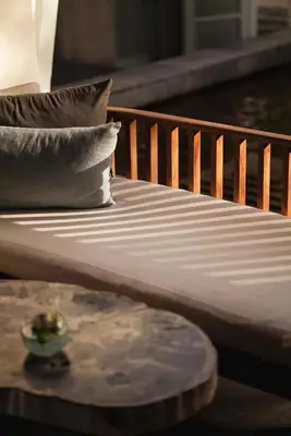 a close up of a bed with pillows and a table at Amatara Welleisure Resort in Panwa Beach