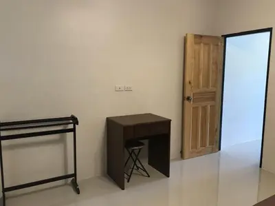 a room with a desk and a door and a stool at Buncha Place in Bang Tao Beach