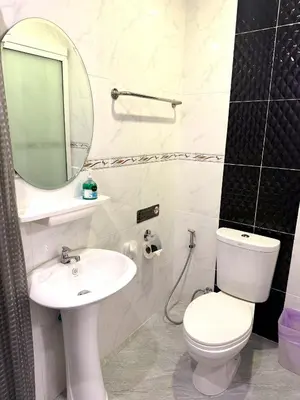 a bathroom with a toilet and a sink and a mirror at Buncha Place in Bang Tao Beach