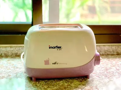 a toaster is sitting on a counter next to a window at Kannapat House in Ban Nong Thale
