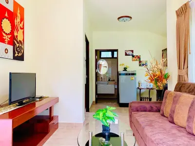 a living room with a couch and a table at Kannapat House in Ban Nong Thale