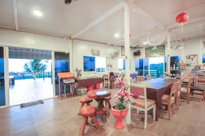 a dining room with a table and chairs at Happy Mountain Airport Resort in Nai Yang Beach