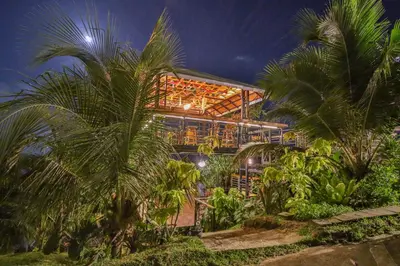 a building with palm trees in front of it at Happy Mountain Airport Resort in Nai Yang Beach
