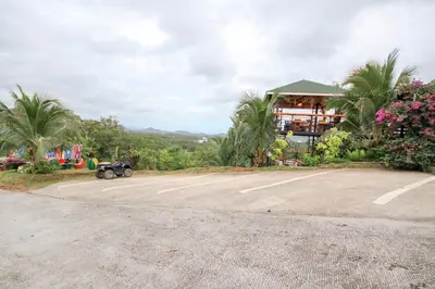an empty parking lot in front of a building at Happy Mountain Airport Resort in Nai Yang Beach