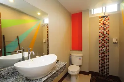 a bathroom with a sink and a tub and a toilet at Phu NaNa Boutique Hotel - SHA Plus in Rawai Beach