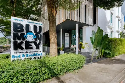 a sign in front of a building with a big key at Blu Monkey Bed & Breakfast Phuket in Phuket Town