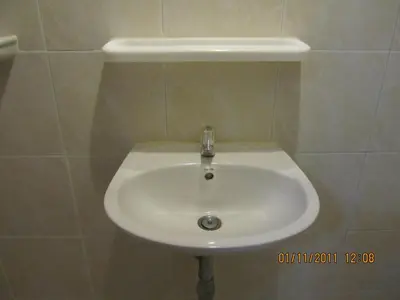 a white sink in a tiled bathroom at Popeye Guesthouse in Ao Nang Beach