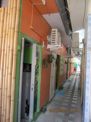 an empty corridor of a building with doors open at Popeye Guesthouse in Ao Nang Beach