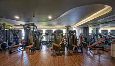 a gym with a lot of treadmills and machines at Zenseana Resort & Spa - Patong, Phuket in Patong Beach