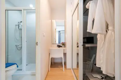 a bathroom with a shower and a toilet and a sink at Bangtao,Layan beach apartment in Bang Tao Beach