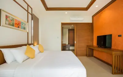 a bedroom with a large bed and a television at Villa Palavee (B1) in Ao Nang Beach