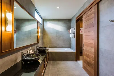 a bathroom with two sinks and a bath tub at Villa Palavee (B1) in Ao Nang Beach