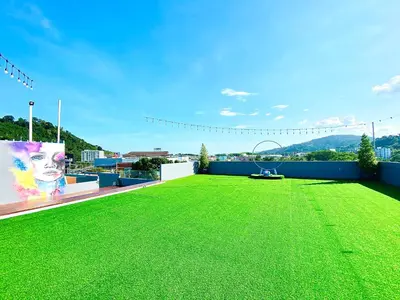 a large lawn on the roof of a building at The Palms Residence - SHA Extra Plus in Phuket Town