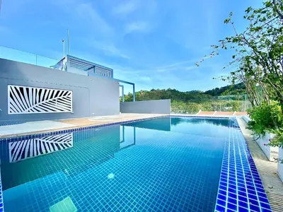 a swimming pool in the backyard of a house at The Palms Residence - SHA Extra Plus in Phuket Town