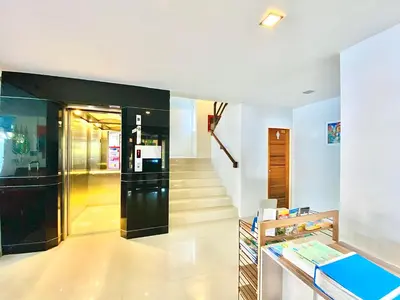 a hallway with a elevator and a stair case at The Palms Residence - SHA Extra Plus in Phuket Town