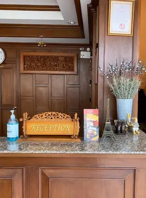 a table with a sign on top of a counter at Baan Sudarat Hotel in Patong Beach