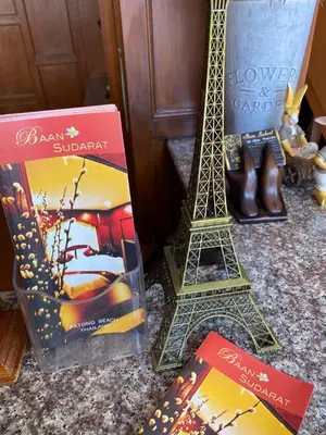 a couple of books and a model of the eiffel tower at Baan Sudarat Hotel in Patong Beach