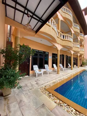 a villa with a swimming pool and a house at Baan Sudarat Hotel in Patong Beach