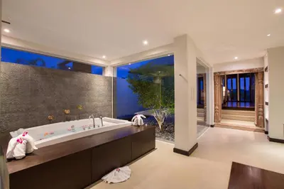 a bathroom with a tub and a large window at Villa Princess Stephanie in Kata Beach