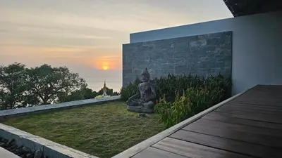 a statue sitting on the side of a building at Villa Princess Stephanie in Kata Beach