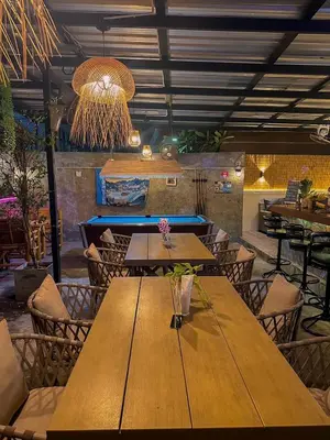 a dining room with wooden tables and chairs at The Villa Residences Resort in Patong Beach