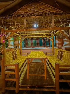 a wooden table and two chairs in a room at The Villa Residences Resort in Patong Beach