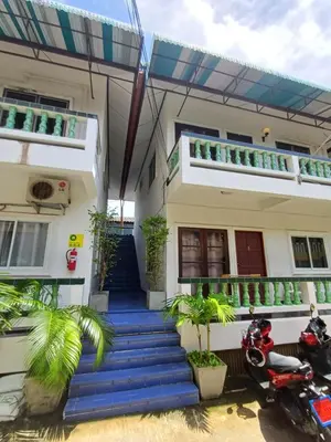 a house with a motorcycle parked in front of it at The Villa Residences Resort in Patong Beach