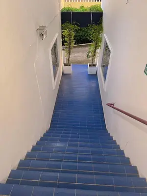 a stairway with blue tiled floors and a stair case at The Villa Residences Resort in Patong Beach