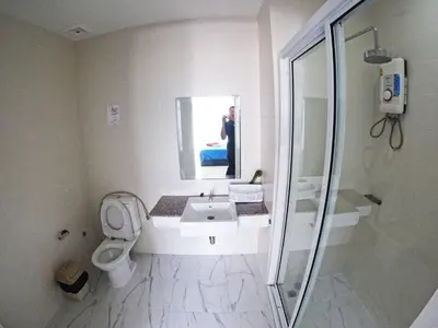 a bathroom with a toilet and a sink and a mirror at At Seacondo-Excellent-B26 in Klong Muang Beach