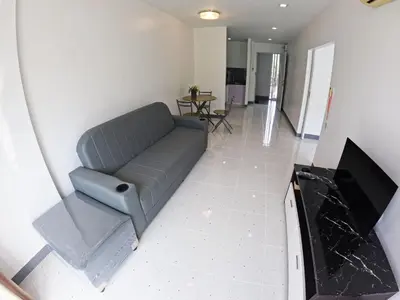 a living room with a couch and a television at At Seacondo-Excellent-B26 in Klong Muang Beach