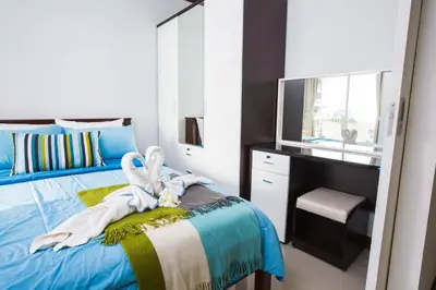 a bedroom with a bed with a dresser and a television at At Seacondo-2 Bedrooms-B35 in Klong Muang Beach