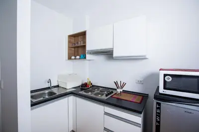a small kitchen with a sink and a microwave at At Seacondo-2 Bedrooms-B35 in Klong Muang Beach