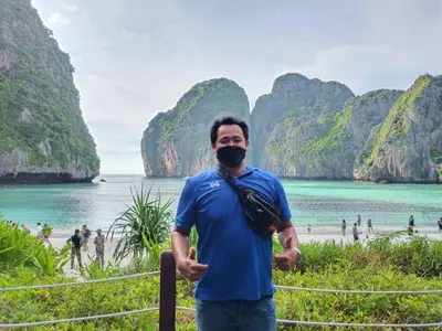 a man wearing a mask in front of a beach at At Seacondo-2 Bedrooms-B35 in Klong Muang Beach