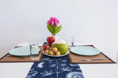 a table with two plates and a bowl of fruit at At Seacondo-1 Bedroom-A12 in Klong Muang Beach