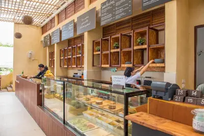 a bakery counter with two women preparing food at PP Charlie Beach Resort in Phi Phi Don