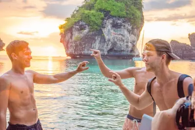 a group of men on a boat in the water at PP Charlie Beach Resort in Phi Phi Don