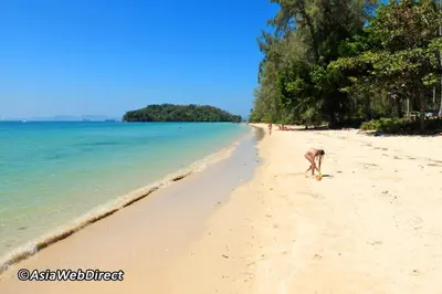 a person walking on the beach at At Seacondo-1 Bedroom-A20 in Klong Muang Beach