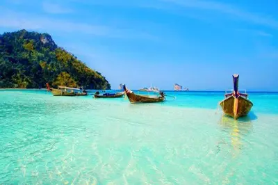 three boats sitting in the water on a beach at At Seacondo-1 Bedroom-A20 in Klong Muang Beach