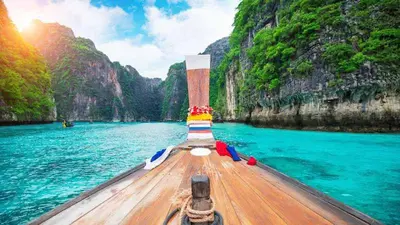 a boat on a body of water with mountains at At Seacondo-1 Bedroom-A20 in Klong Muang Beach