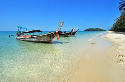two boats sitting on the shore of a beach at At Seacondo-1 Bedroom-A25 in Klong Muang Beach