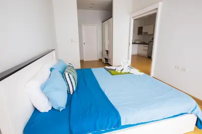 a bedroom with a bed with blue sheets and pillows at At Seacondo-1 Bedroom-A25 in Klong Muang Beach