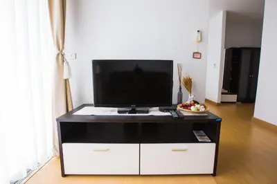 a black and white entertainment center with a flat screen tv on top at At Seacondo-1 Bedroom-A25 in Klong Muang Beach