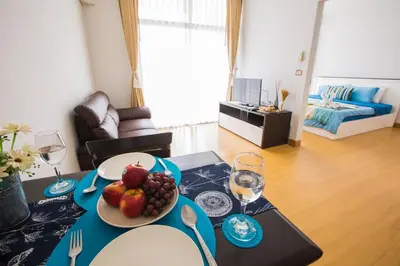 a table with a plate of fruit on it in a living room at At Seacondo-1 Bedroom-A25 in Klong Muang Beach