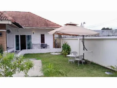 a patio with an umbrella and a table and chairs at 3BR Villa near Laguna beach in Bang Tao Beach