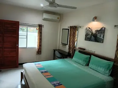 a bedroom with a bed and a desk and a window at 3BR Villa near Laguna beach in Bang Tao Beach