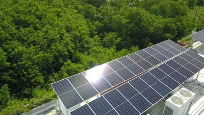 an aerial view of solar panels on top of a building at Le Resort and Villas in Rawai Beach